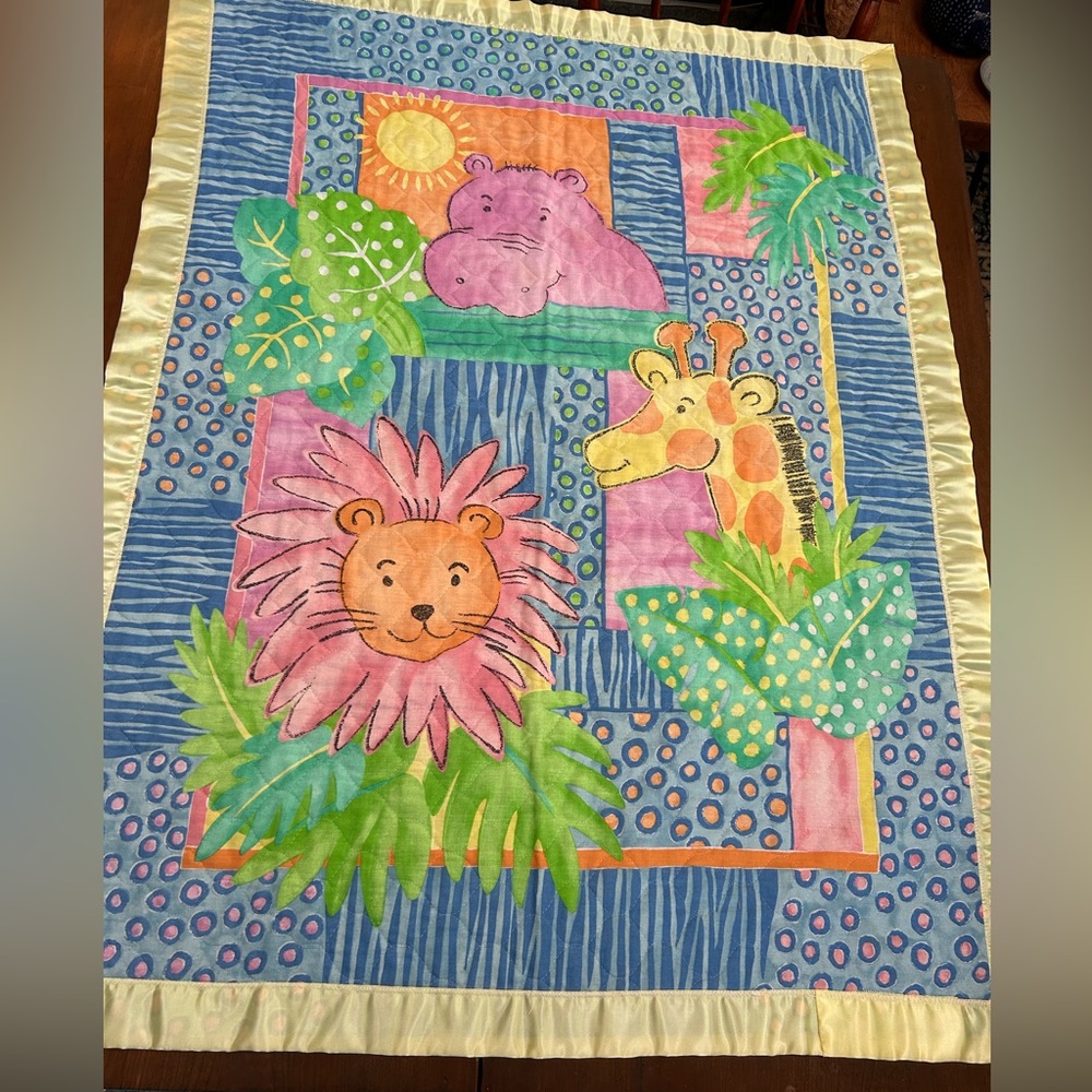 Colorful Animal Print Baby Blanket —34.5 x45.5” edged in yellow satin binding.